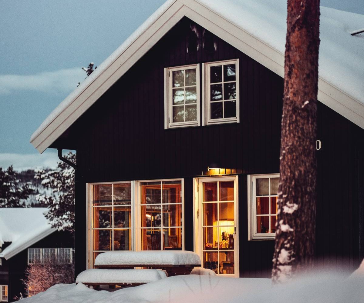 Hytte på fjellet i snølandskap